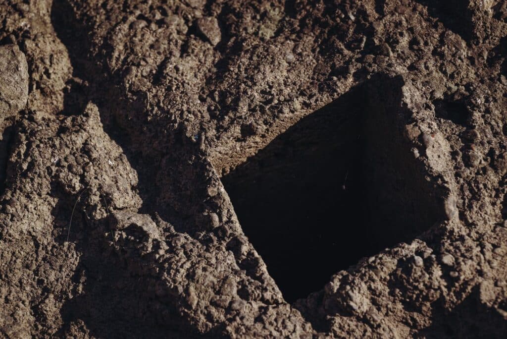 Excavation cut showing a hard cemented soil layer similar to Las Vegas caliche